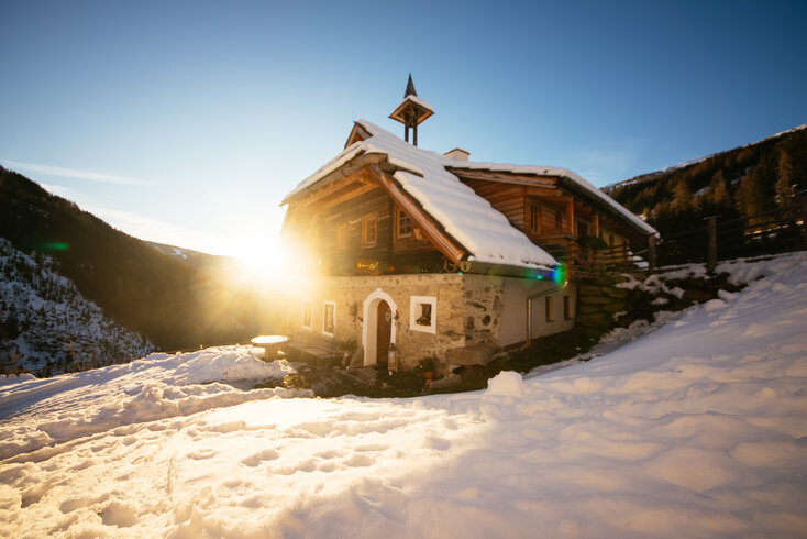 Die Kärntner Sandrisserhütte im Sonnenuntergang | © Urlaub am Bauernhof Kärnten / Daniel Gollner